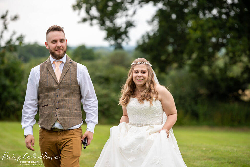 Bride and groom walking towards their wedding guests