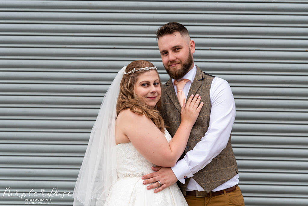 Couple in front of metal barn door