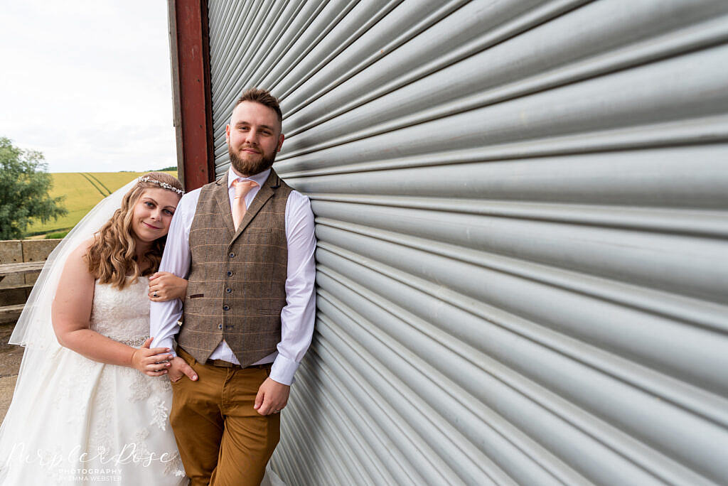 Couple leaning on barn door