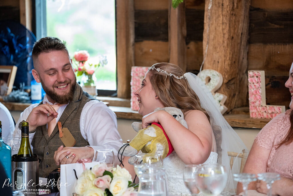 Couple laughing during wedding speaches