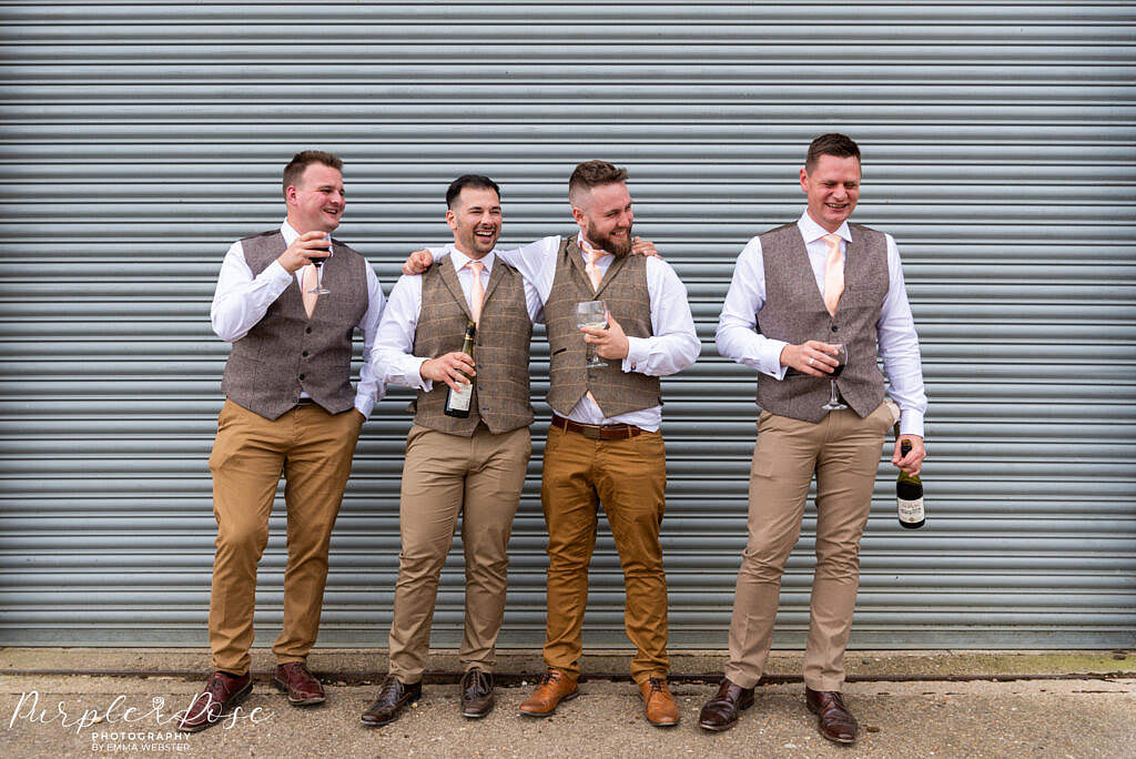 Groom laughing with his groomsmen