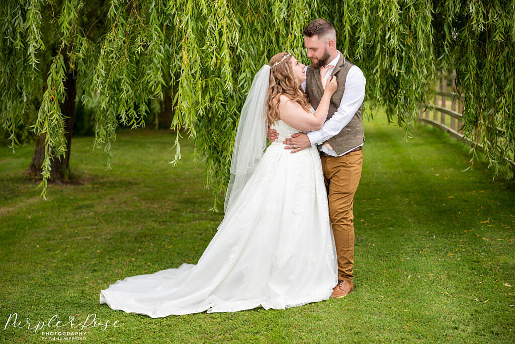 Couple beneath a weeping willow tree