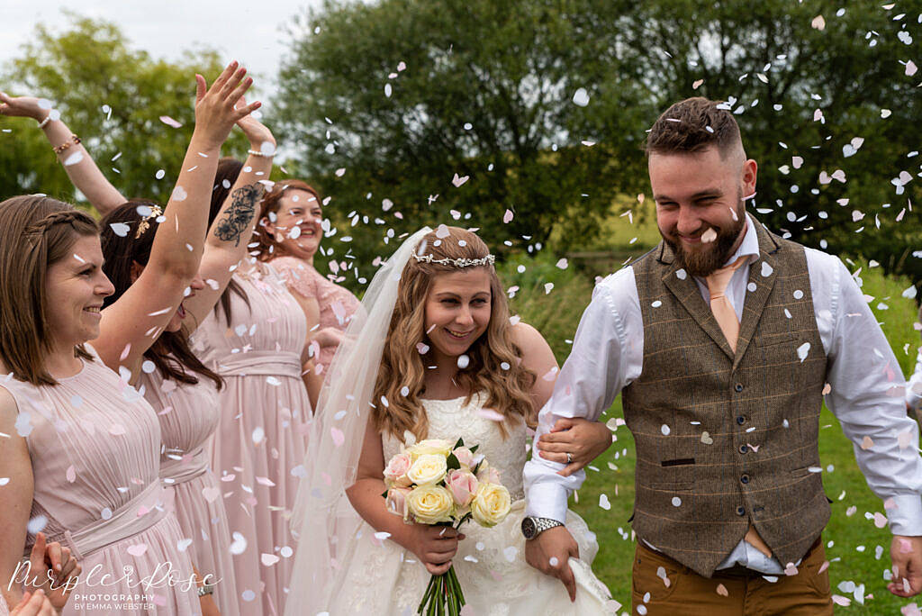 bride and groom being showered with confetti