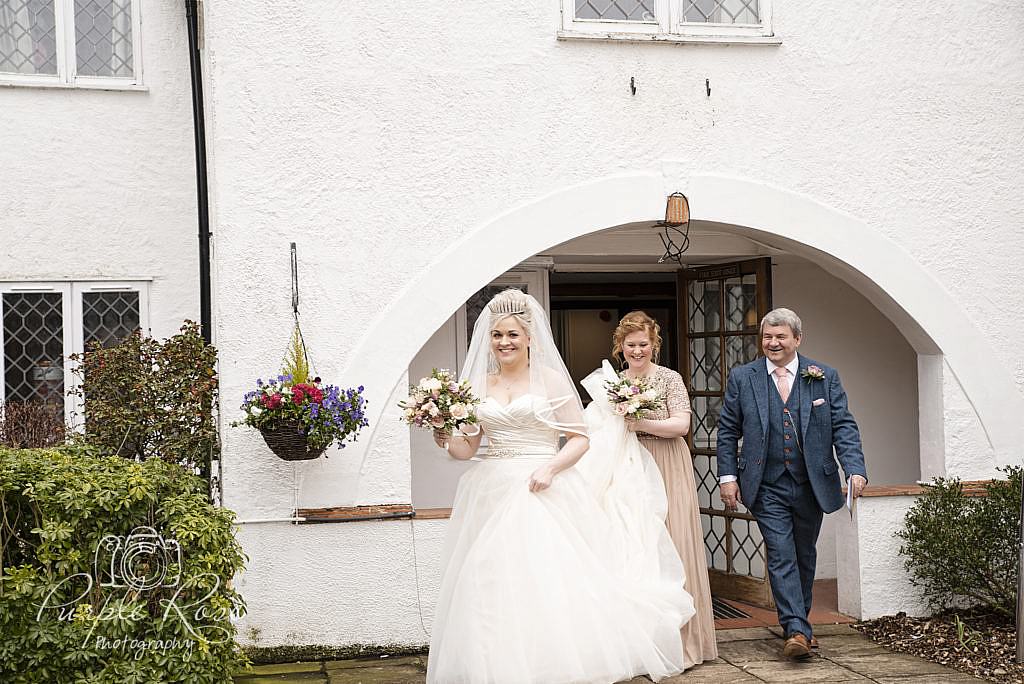 Bride and bridal party walking to the wedding ceremony