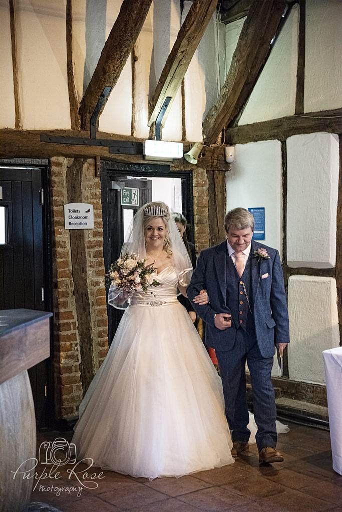 Father walking his daughter to her wedding ceremony