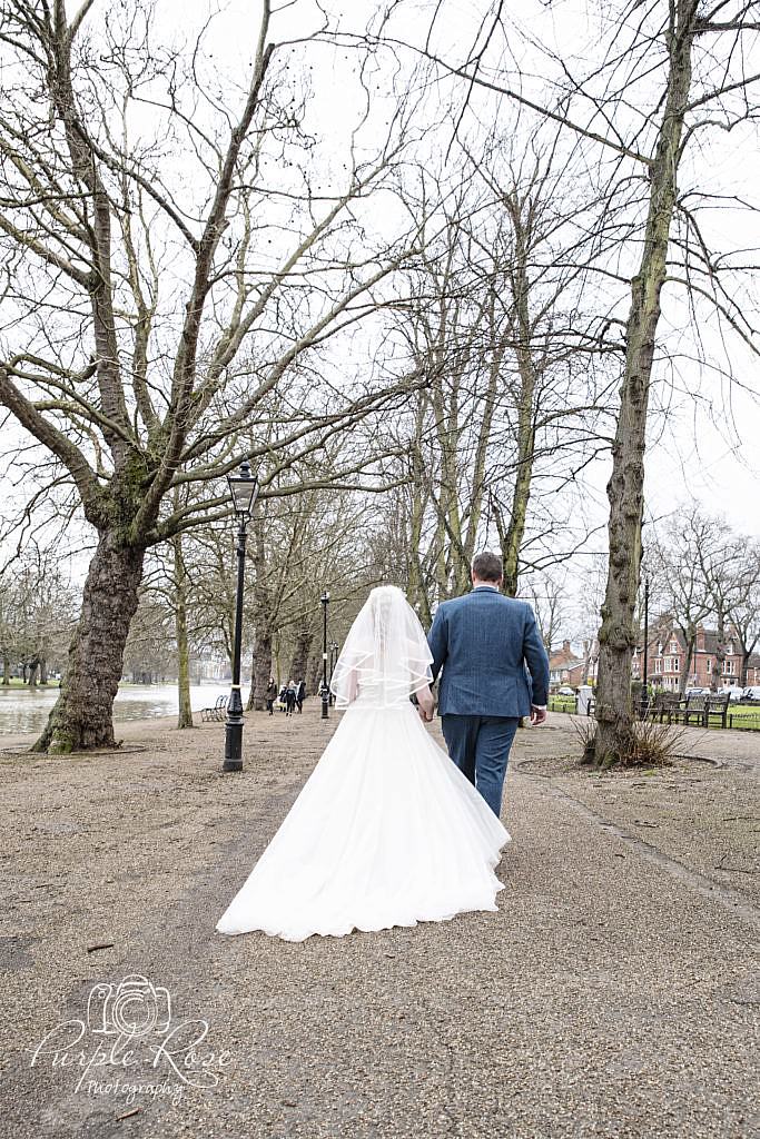 Bride and groom walking besides Bedford River Bank
