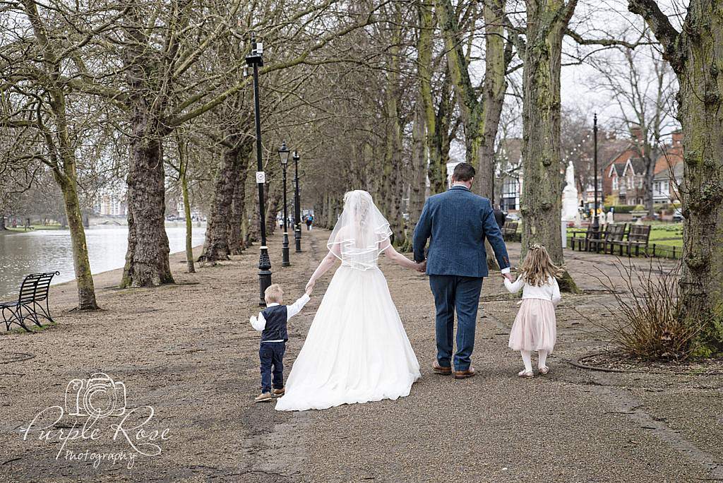 Bride, groom and their children walking together