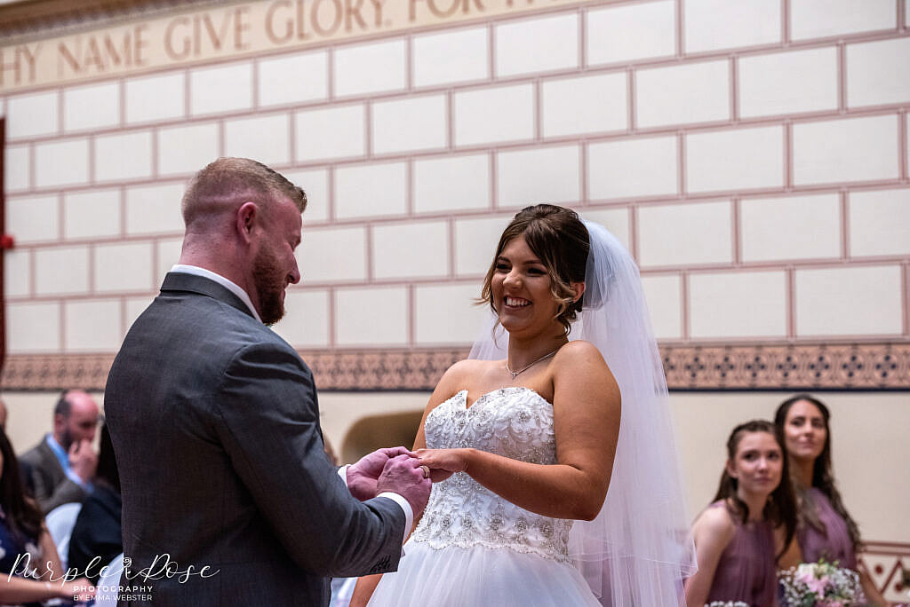 Bride and groom holding hands during the wedding ceremony