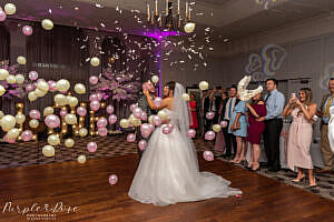 Photo of balloons being dropped during bride and grooms first dance on their wedding day in Milton Keynes