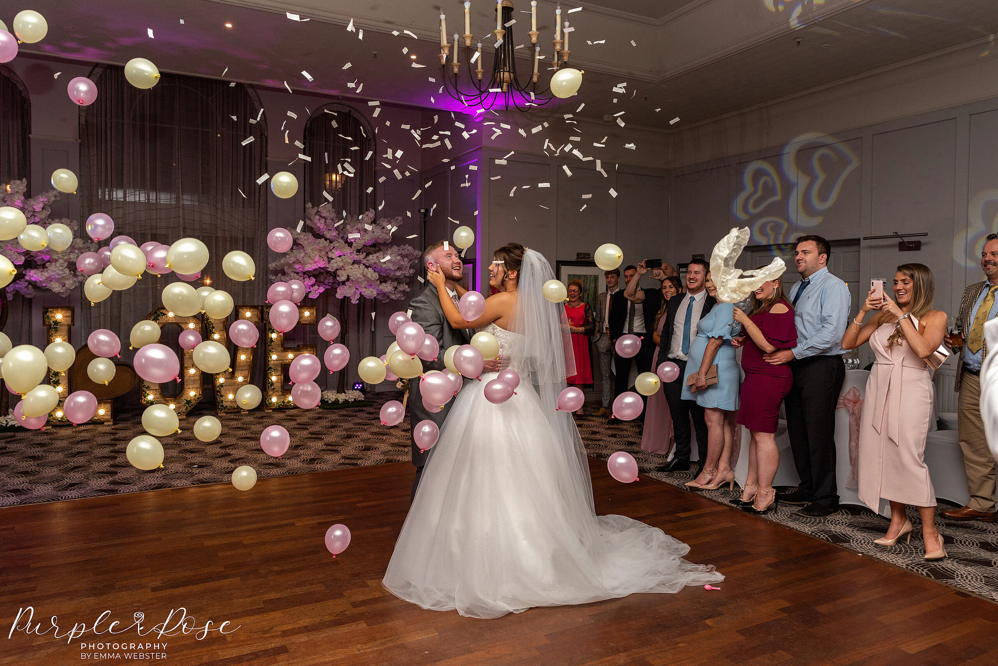 Photo of balloons being dropped during bride and grooms first dance on their wedding day in Milton Keynes