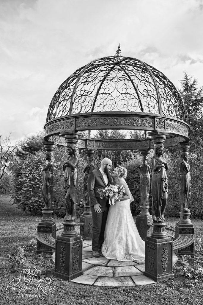 Bride and groom enjoying a quiet moment together in the garden of their wedding venue