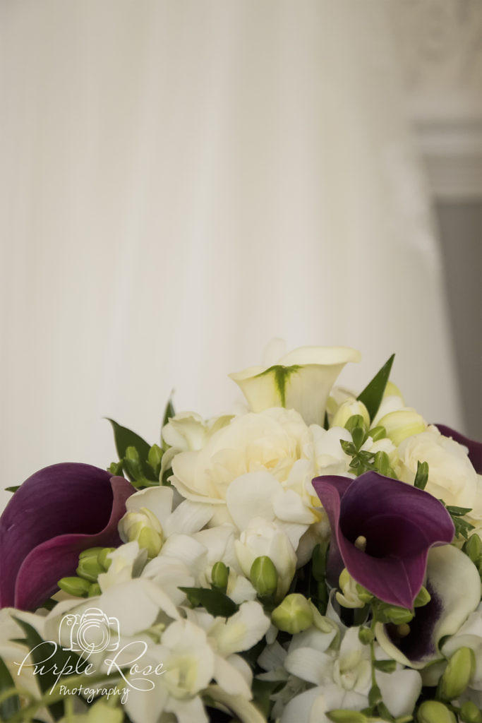 Bridal bouquet with wedding dress in the background