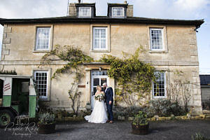 Bride and groom standing outside their wedding venue