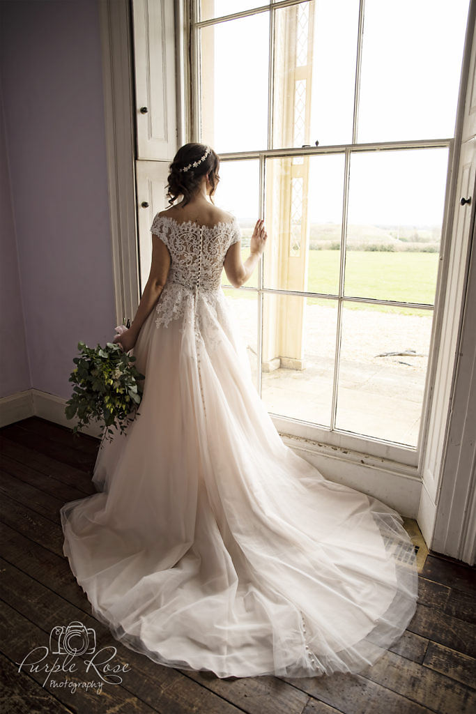 Bride looking out window