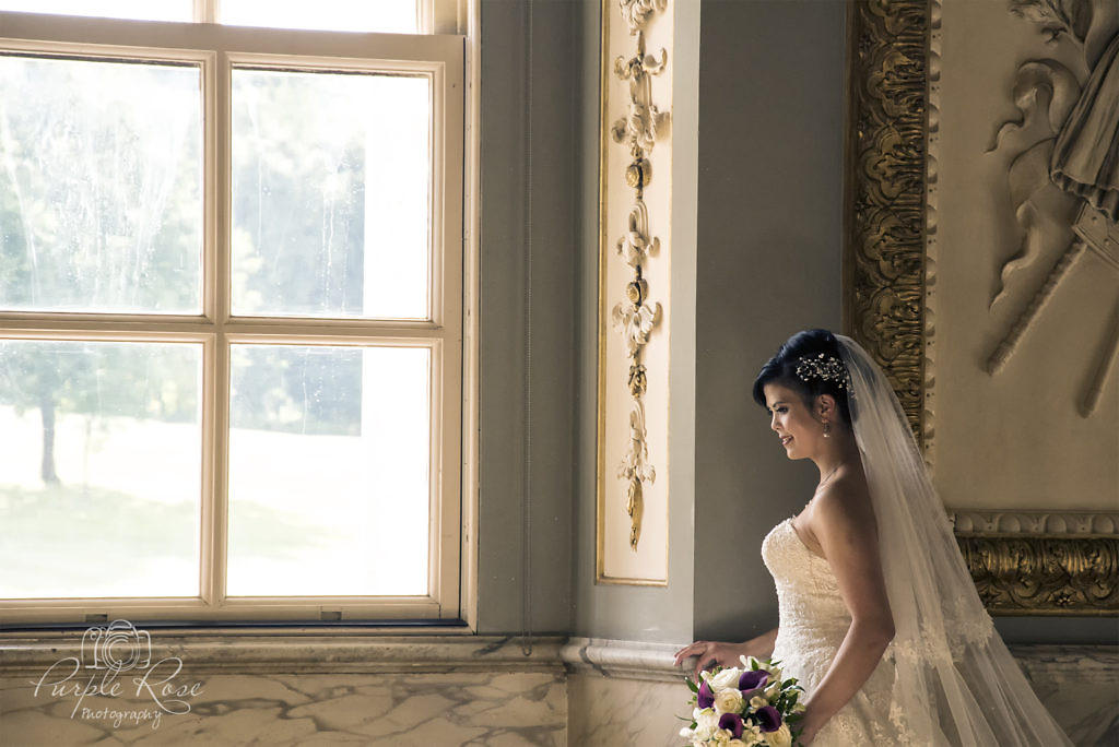 Bride looking out a window