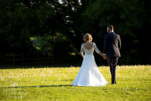 Bride and groom walking towards the sunset