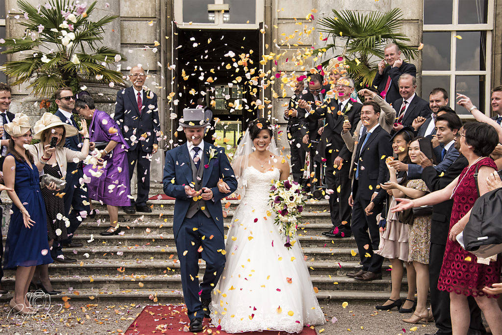 Bride & Groom covered in confetti at Moor Park Mansion