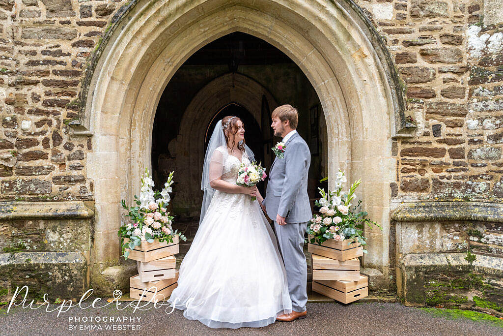 Bride and groom standing outside the church