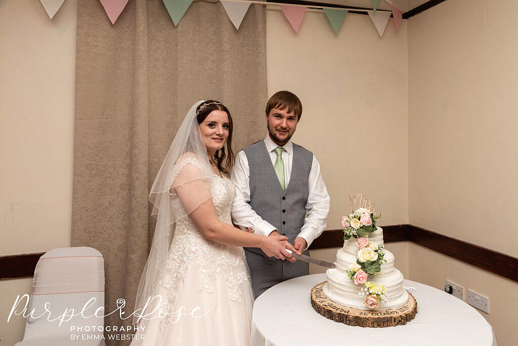 Bride and groom cutting their wedding cake