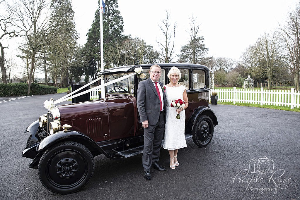 Bride and Groom with their wedding car