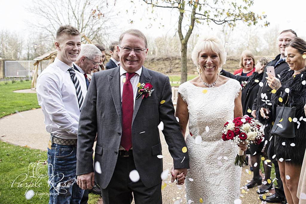 Bride and Groom being showered in confetti