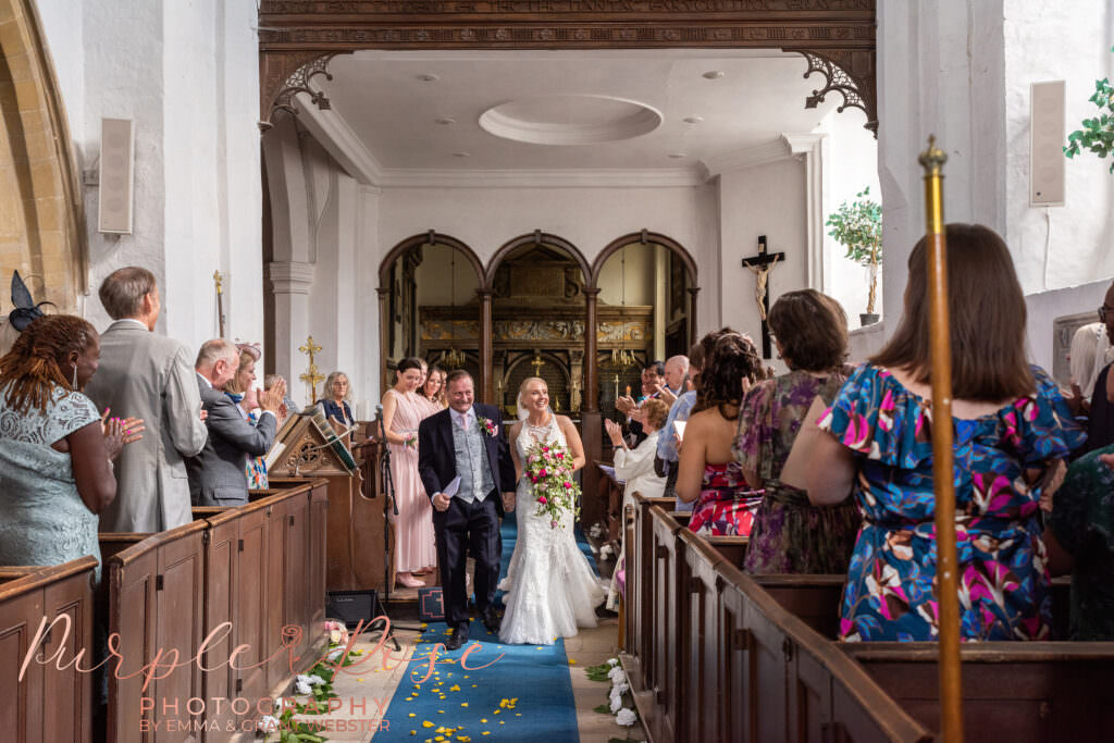 Bride and groom leaving Chicheley Church after their wedding  in Milton Keynes