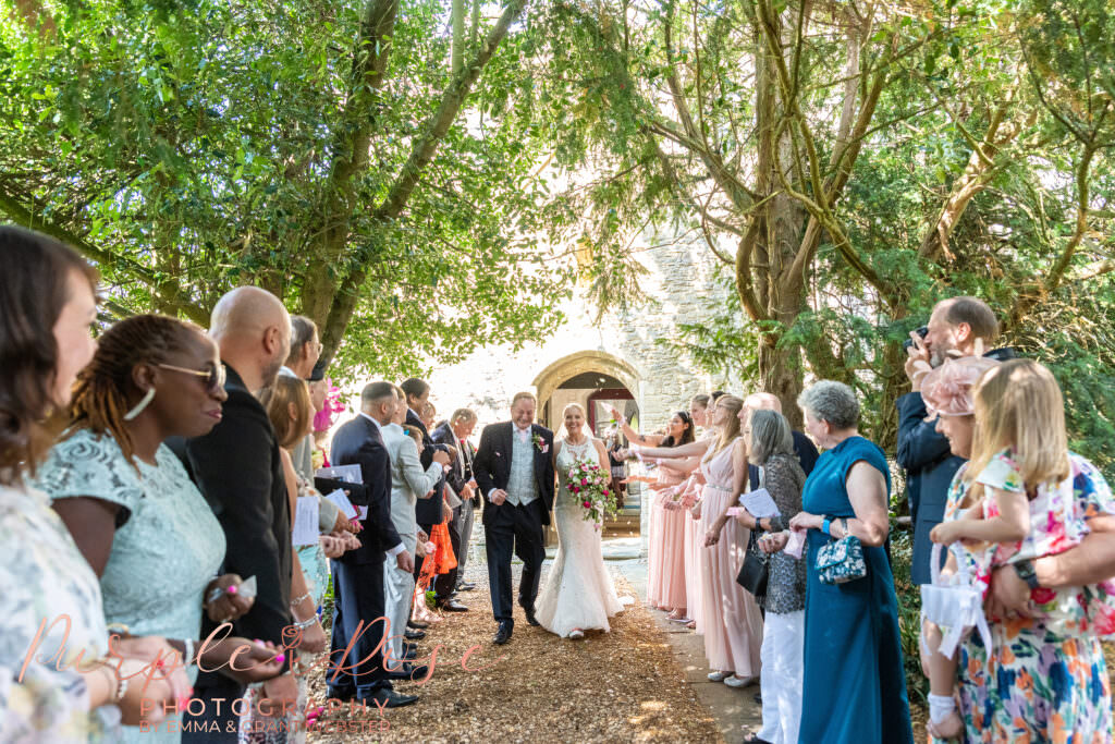 Photograph of a bride and groom leaving their church after the wedding ceremony in Milton Keynes