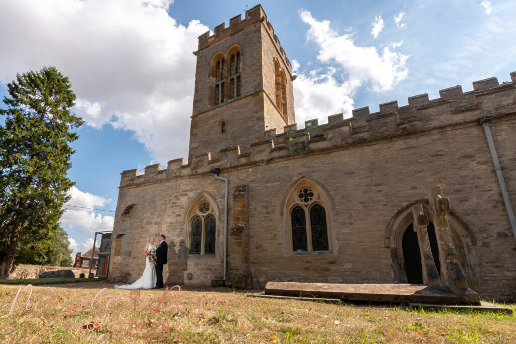 Photo of bride and groom outside Chicheley Church  in Milton Keynes