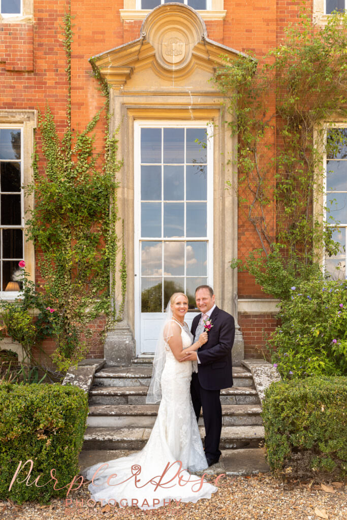 Photograph of bride and groom outside their wedding venue  in Milton Keynes