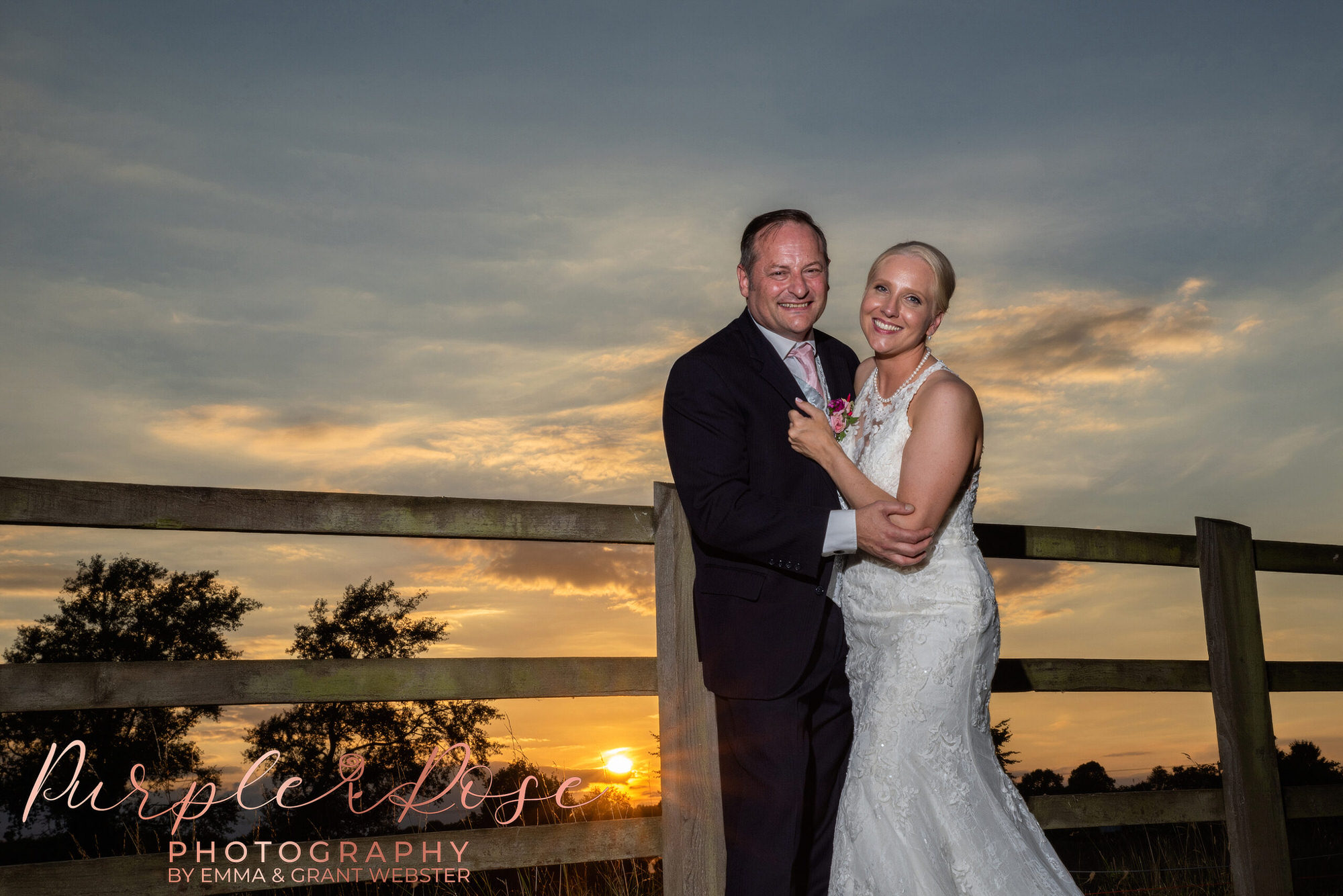 Bride and groom in front of a sunset