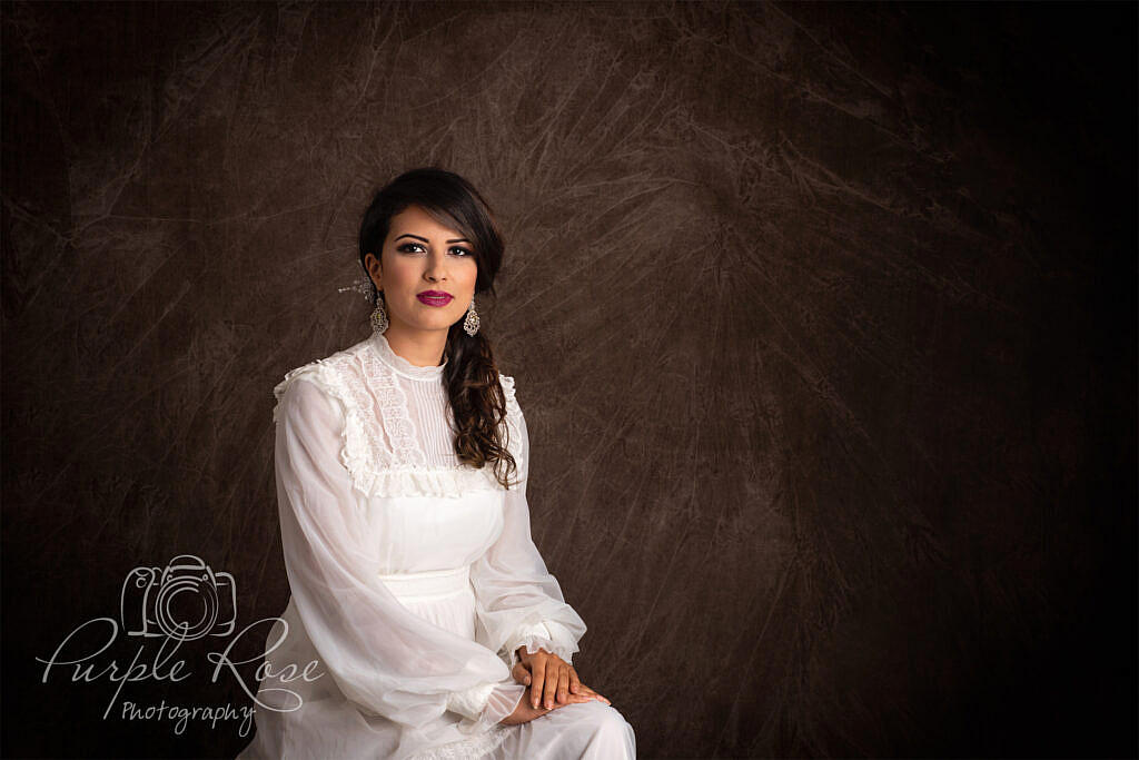 Photo of woman sitting in vintage wedding dress