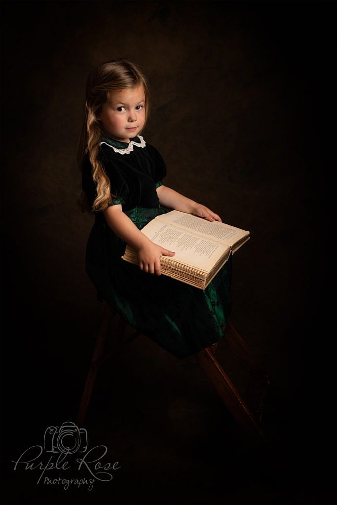Portrait of child reading a book