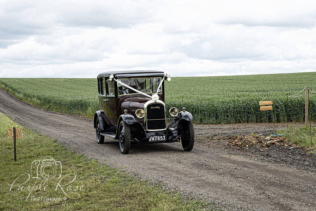 Wedding car arriving at reception venue