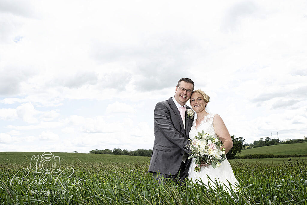 Bride and groom surrounded by crops