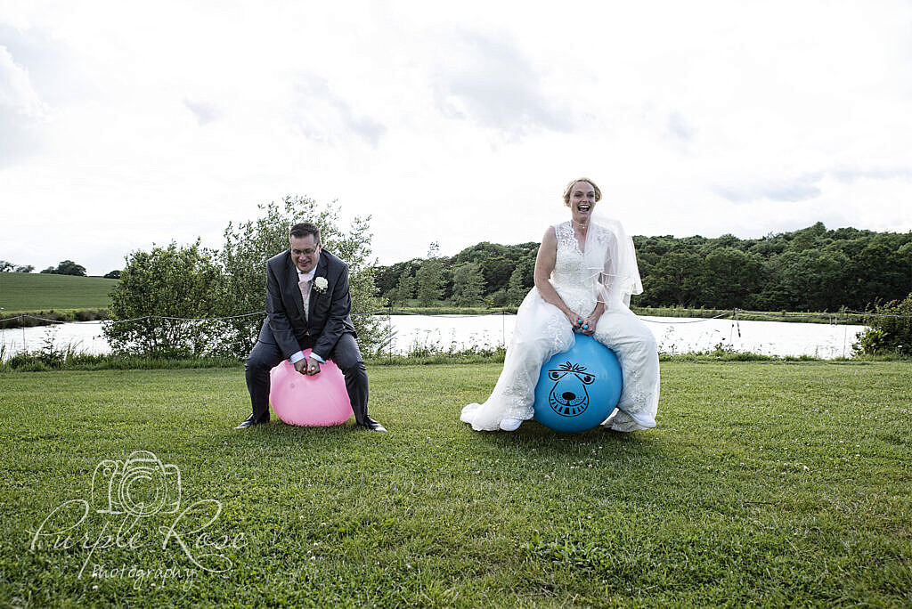 Bride and Groom racing on a space hopper