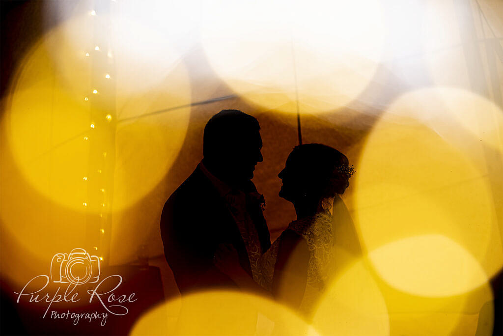 Silhouette of bride and groom dancing