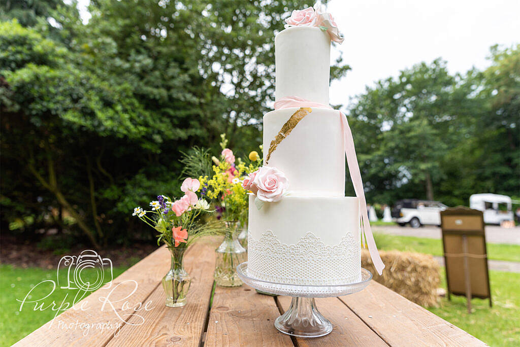 White wedding cake with pink sugar craft roses