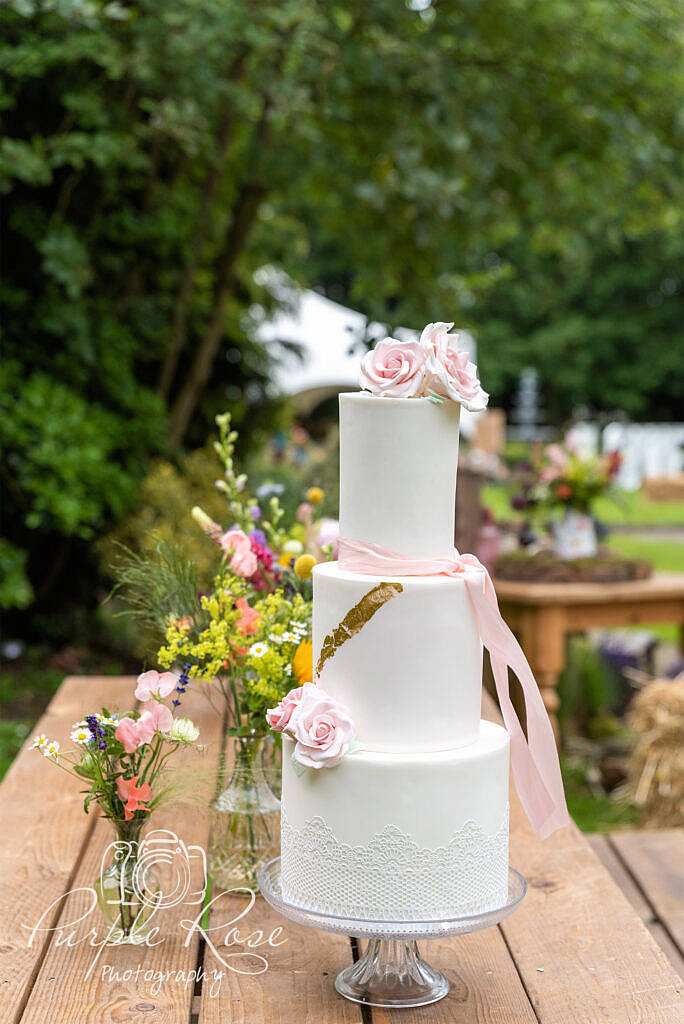 Wedding cake surrounded by flowers