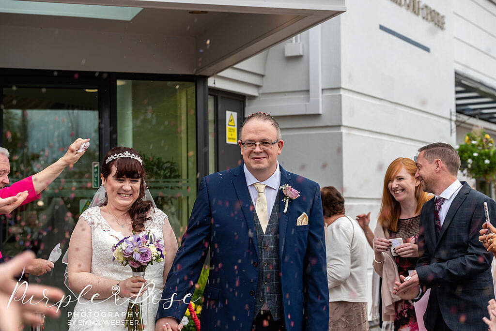 Bride and groom leaving their wedding