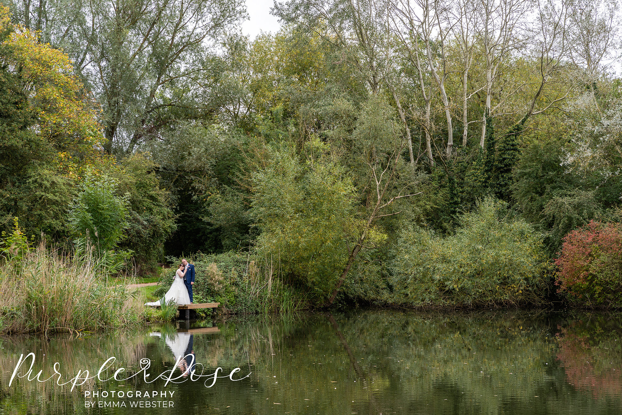 Bride and groom by a lake