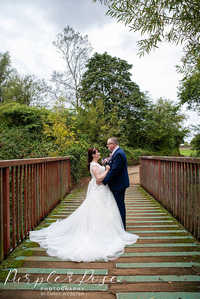 bride and groom on a bridge