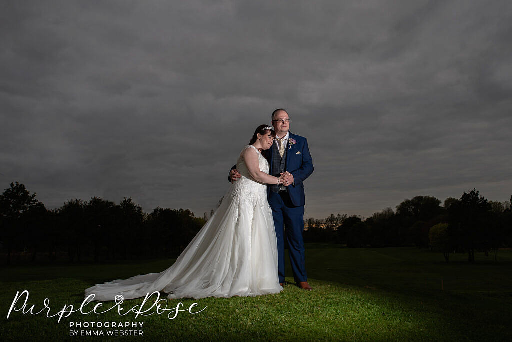 Bride and groom in front of a stormy sky