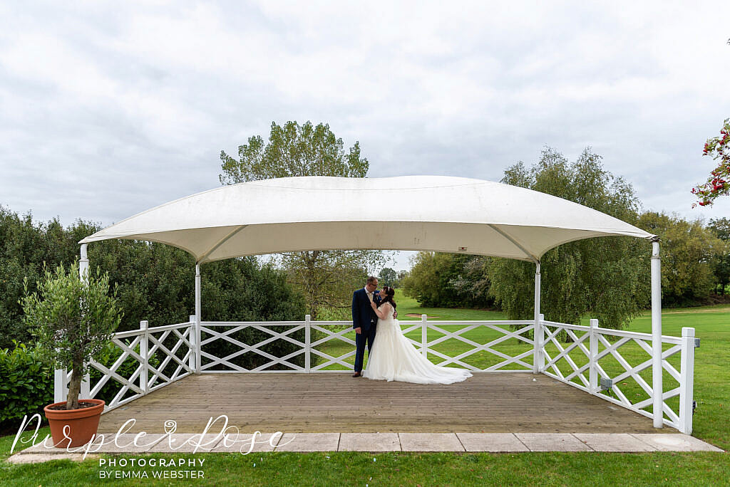 Bride and groom under a canopy
