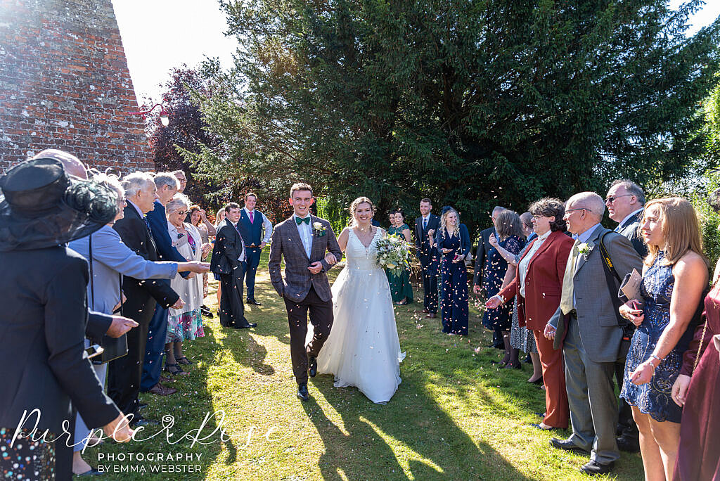 bride and groom surrounded by wedding guests