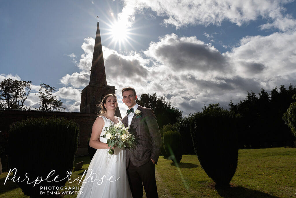 Bride and groom in front of their church