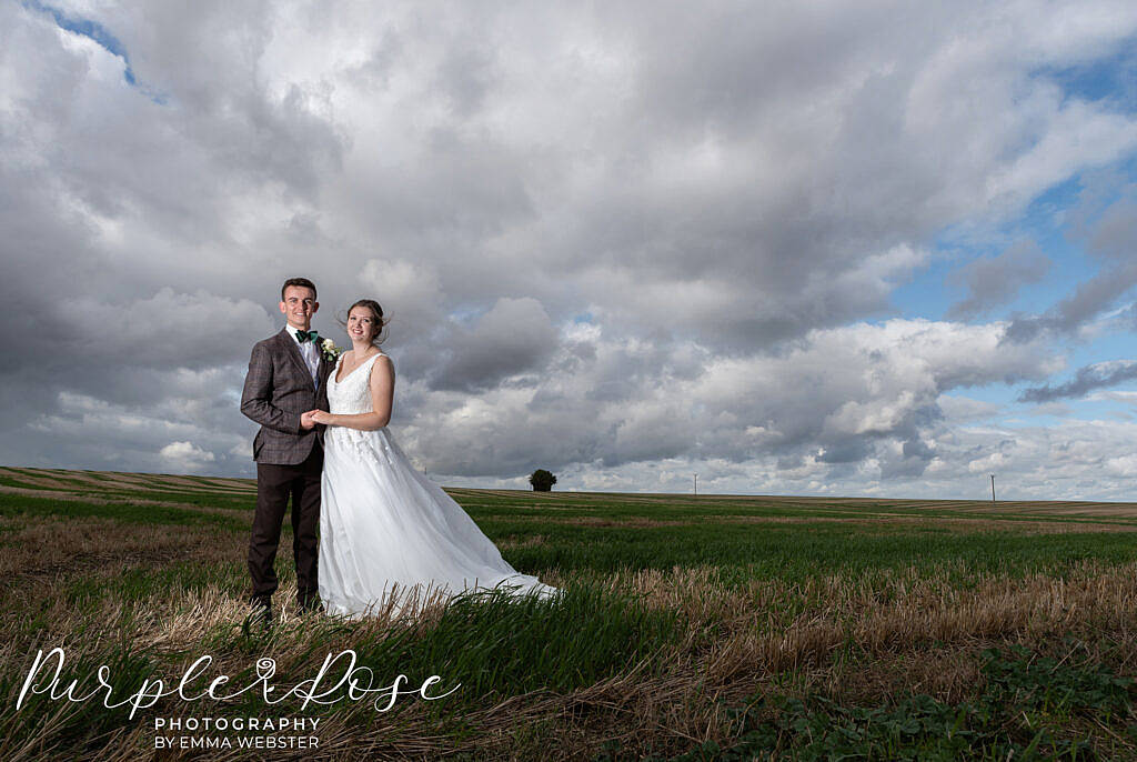 Bride and groom in a field