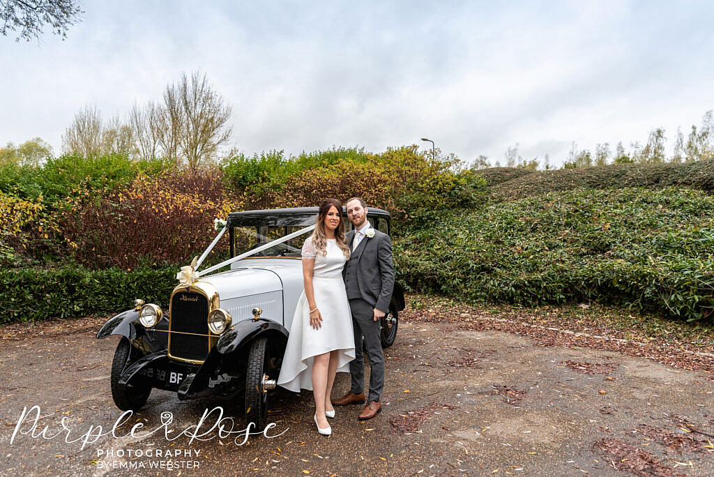 bride and groom with the wedding car