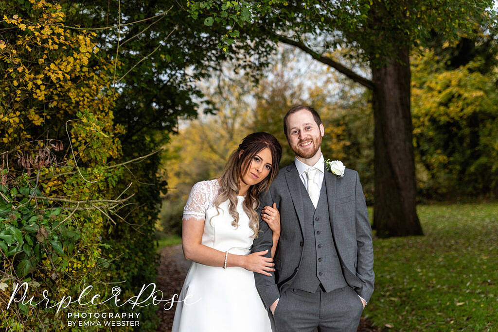 Bride and groom framed by trees