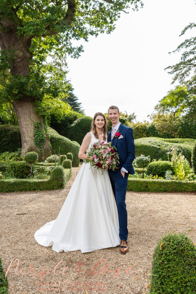 Photo of bride and groom in the garden of their wedding venue in Milton Keynes