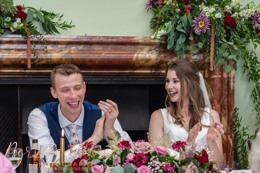 Photo of bride and groom laughing during their speeches on their wedding day in Milton Keynes